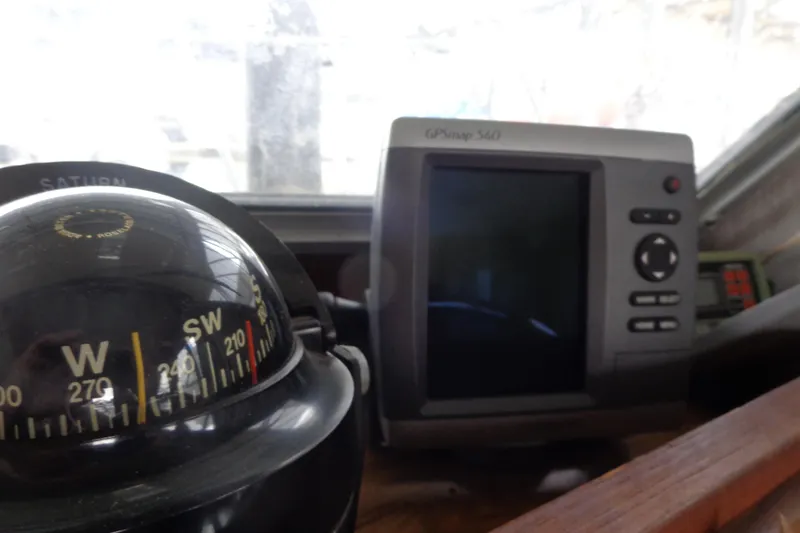 Slide: The Image of Compass and GPS device inside a 1976 Tolly sedan, showcasing navigation tools. - 24