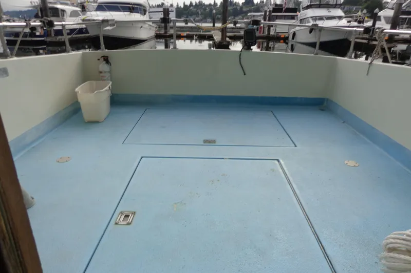 Slide: The Image of Empty deck of a 1976 Tolly sedan boat at a marina. - 6