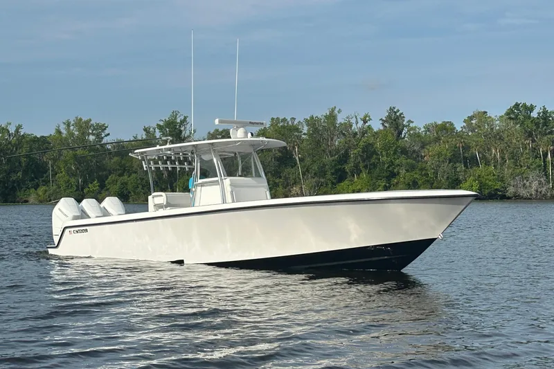 Slide: The Image of 2024 Contender 39 ST boat with Mercury engines and dual livewells, featuring Matthew 8:25-27 inscription. - 10