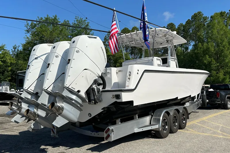 Slide: The Image of 2024 Contender 39 ST boat on trailer, equipped with fishing rods and Mercury engines. - 2