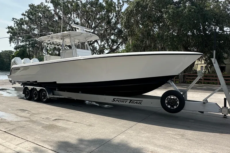 Slide: The Image of 2024 Contender 39 ST boat deck with fishing rods and Mercury engines. - 20