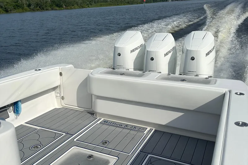 Slide: The Image of 2024 Contender 39 ST boat on Sport Trail trailer in parking lot. - 23