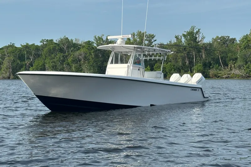 Slide: The Image of 2024 Contender 39 ST boat console with steering wheel and navigation equipment. - 7