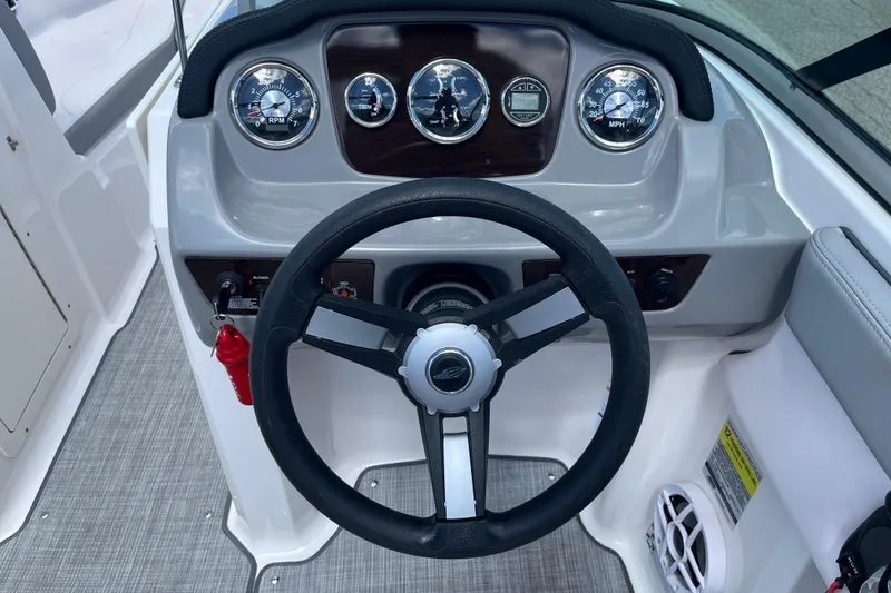 Slide: The Image of 2021 Chaparral 21 SSi boat dashboard with steering wheel and gauges. - 11