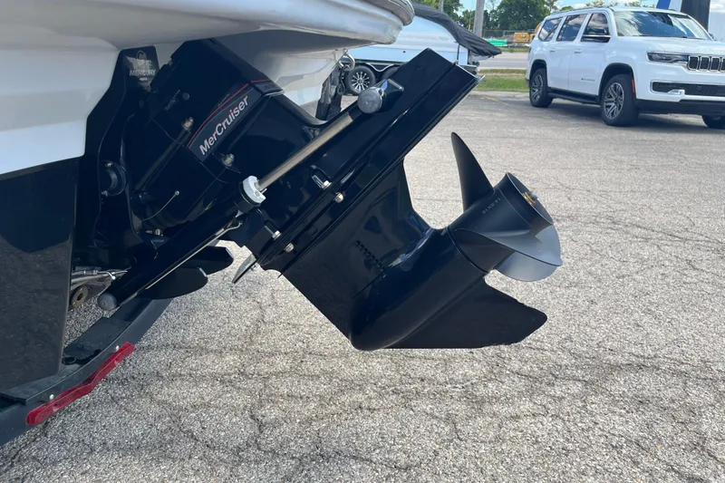 Slide: The Image of 2021 Chaparral 21 SSi boat with MerCruiser outboard motor on pavement. - 15