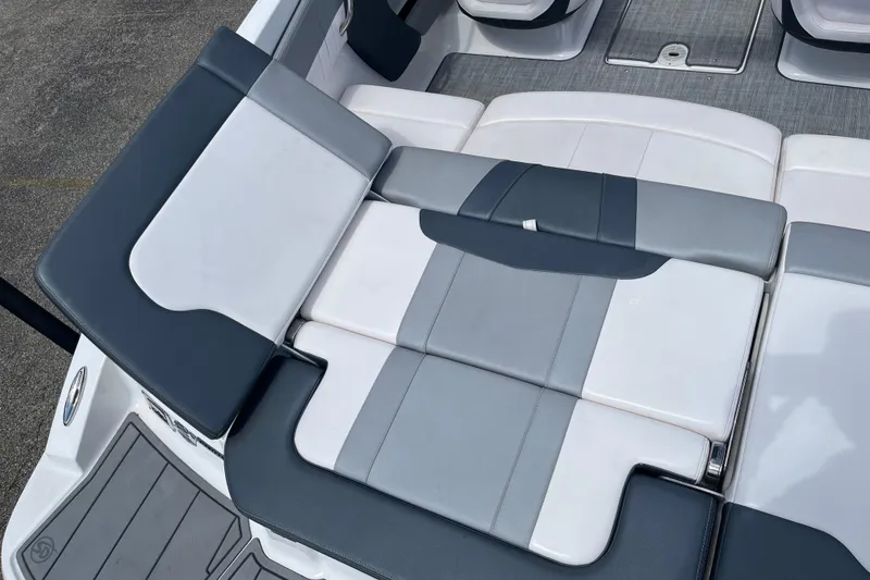 Slide: The Image of 2021 Chaparral 21 SSi boat interior with gray and white seating arrangement. - 16