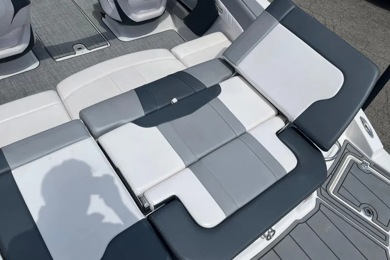 Slide: The Image of 2021 Chaparral 21 SSi boat interior with gray and white seating arrangement. - 17
