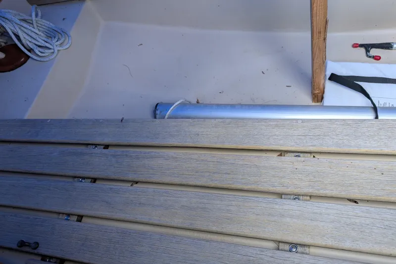 Slide: The Image of Interior of 1981 Cape Dory Typhoon sailboat with wooden slats and nautical equipment. - 6