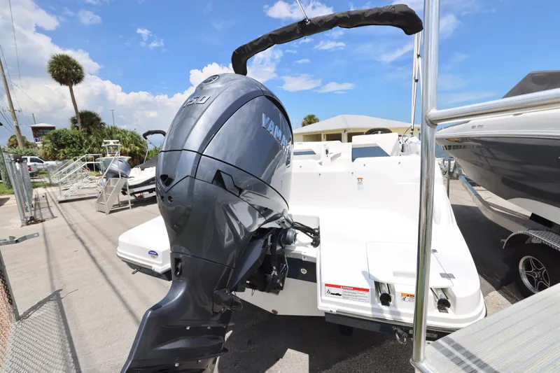 Slide: The Image of 2026 Hurricane SunDeck Sport 205 OB boat on trailer under clear sky. - 17