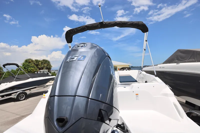Slide: The Image of 2026 Hurricane SunDeck Sport 205 OB with Yamaha outboard motor, parked outdoors. - 18
