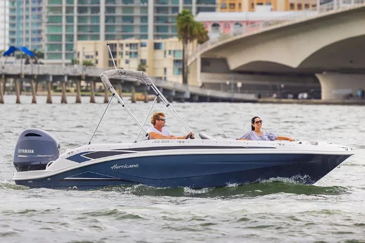 Slide: The Image of 2025 Hurricane SunDeck Sport 205 OB cruising on a sunny lake. - 20