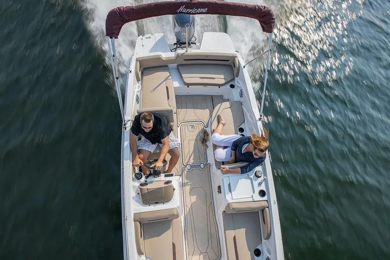 Slide: The Image of 2025 Hurricane SunDeck Sport 205 OB boat interior with stereo system and cushioned seating. - 24