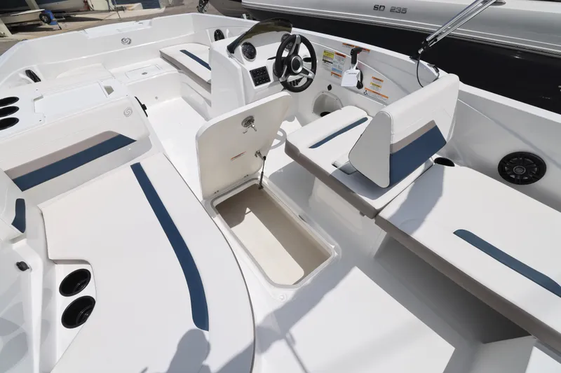 Slide: The Image of 2026 Hurricane SunDeck Sport 205 OB boat interior with seating and steering wheel. - 4