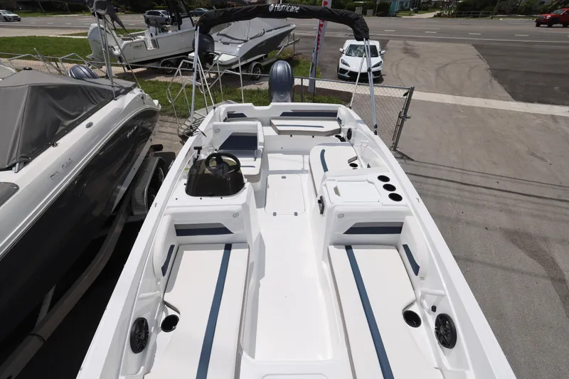 Slide: The Image of 2026 Hurricane SunDeck Sport 205 OB boat interior with white seating and blue accents. - 6