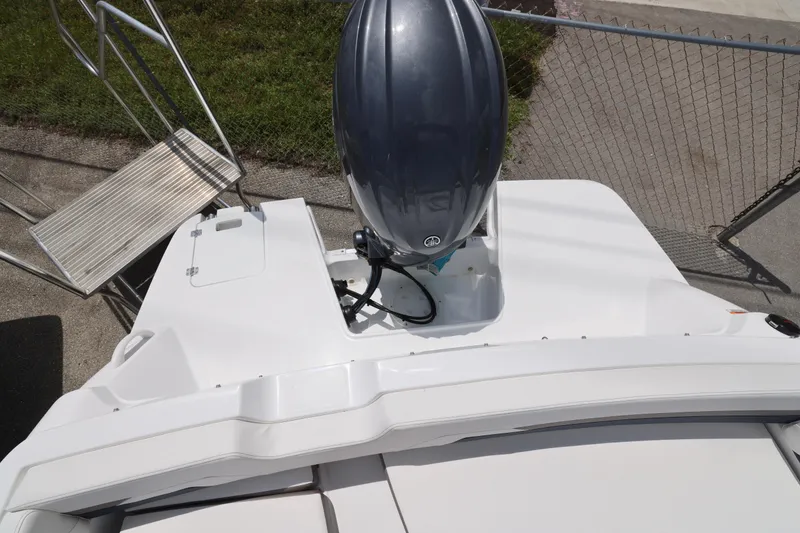 Slide: The Image of 2026 Hurricane SunDeck Sport 205 OB boat, spacious seating, sleek design, parked outdoors. - 7