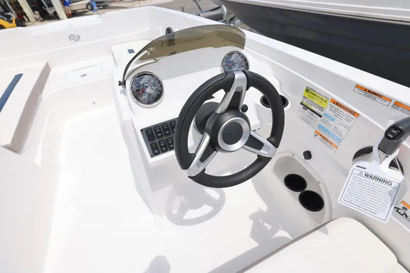 Slide: The Image of 2026 Hurricane SunDeck Sport 205 OB boat with open storage compartment and ladder. - 9