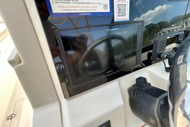 Slide: The Image of 2022 Cobia 240 Dual Console boat dashboard with Garmin navigation system. - 17