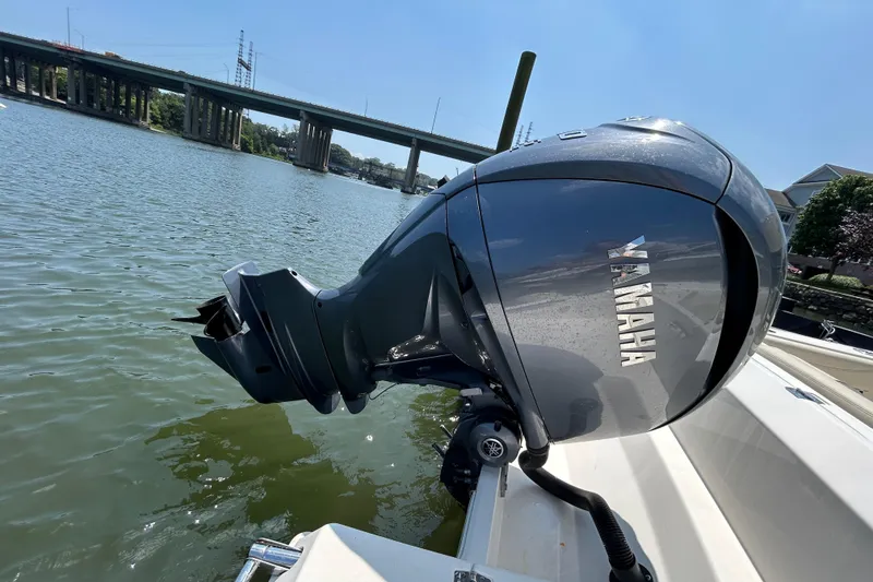 Slide: The Image of Yamaha outboard motor on 2022 Cobia 240 Dual Console boat, near a bridge. - 3