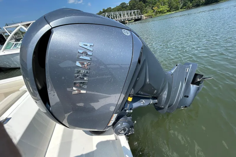 Slide: The Image of Yamaha outboard motor on 2022 Cobia 240 Dual Console boat, docked on a sunny day. - 4