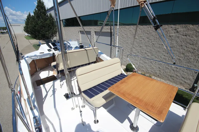 Slide: The Image of 2020 Ranger Tugs R-31 Command Bridge LE with seating and table on deck. - 11