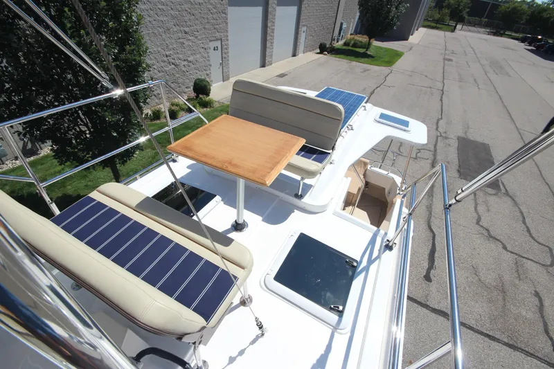 Slide: The Image of 2020 Ranger Tugs R-31 Command Bridge LE with seating and table on deck. - 12