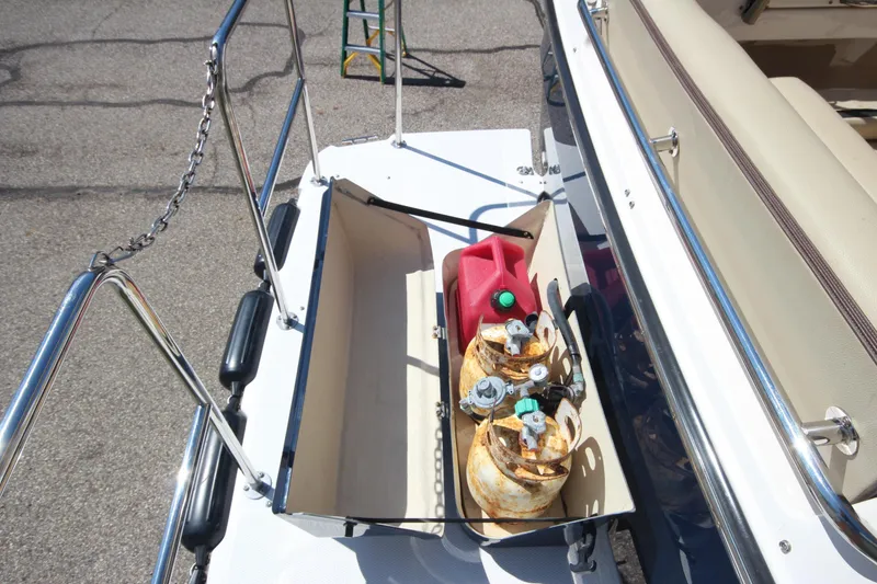 Slide: The Image of 2020 Ranger Tugs R-31 Command Bridge LE deck with propane tanks and fuel container. - 18