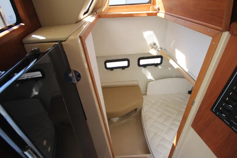 Slide: The Image of 2020 Ranger Tugs R-31 Command Bridge LE cabin interior with cozy sleeping area. - 30