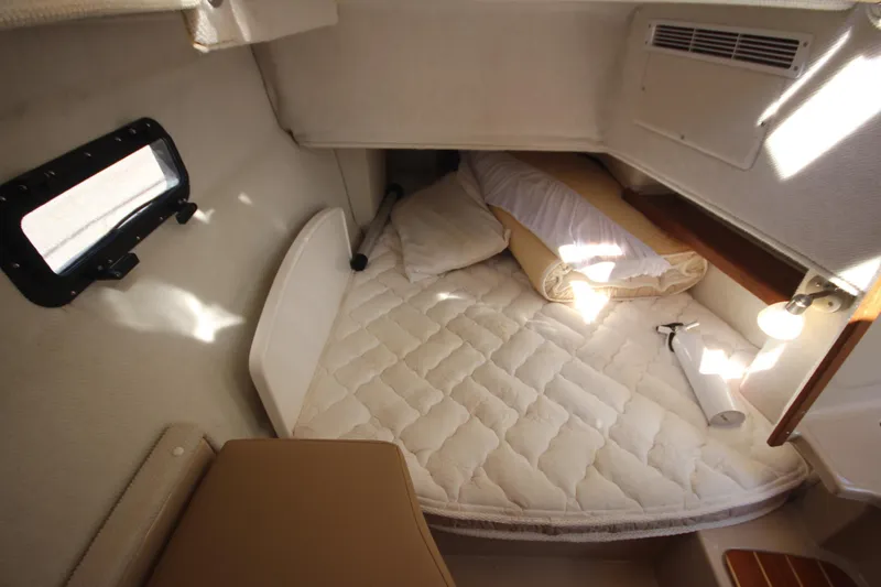 Slide: The Image of Cozy cabin interior of 2020 Ranger Tugs R-31 Command Bridge LE with bedding and window. - 32