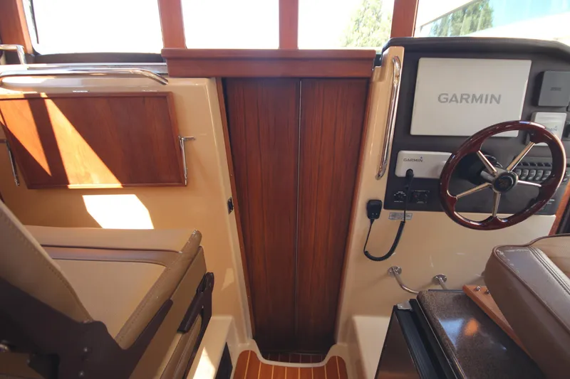 Slide: The Image of 2020 Ranger Tugs R-31 Command Bridge LE helm with Garmin navigation system. - 44