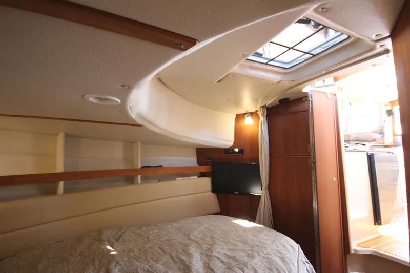 Slide: The Image of 2020 Ranger Tugs R-31 Command Bridge LE cabin interior with bed, TV, and skylight. - 47