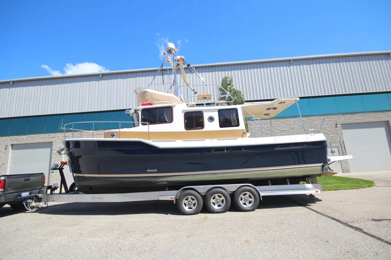 Slide: The Image of 2020 Ranger Tugs R-31 Command Bridge LE on trailer, parked outdoors. - 6