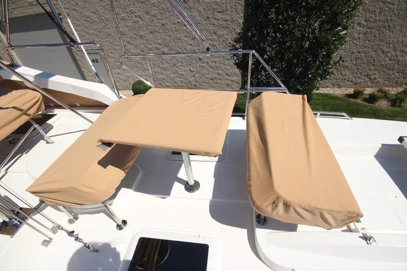 Slide: The Image of 2020 Ranger Tugs R-31 Command Bridge LE with beige seating covers on deck. - 9