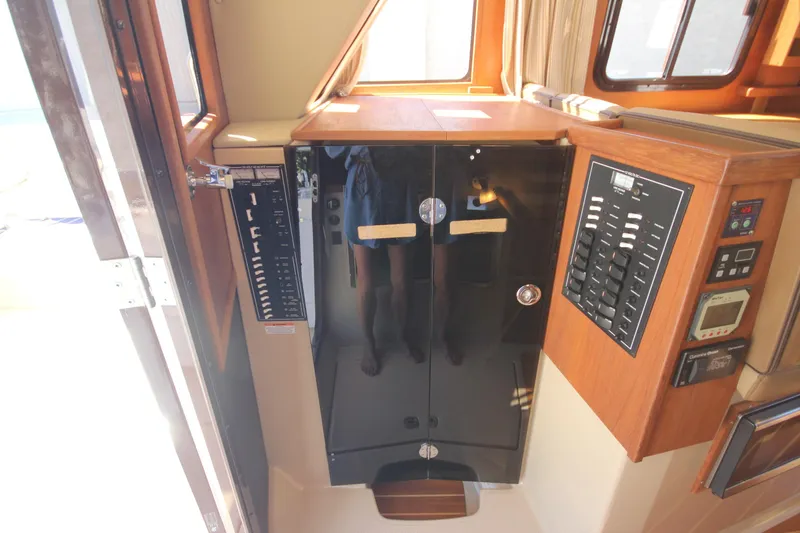 Slide: The Image of 2020 Ranger Tugs R-31 Command Bridge LE interior control panel and cabinetry. - 29