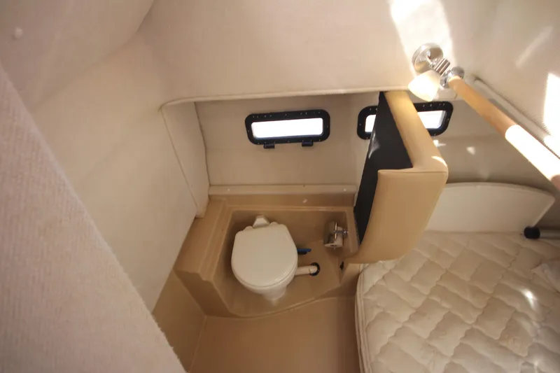 Slide: The Image of 2020 Ranger Tugs R-31 Command Bridge LE interior bathroom with toilet and windows. - 31