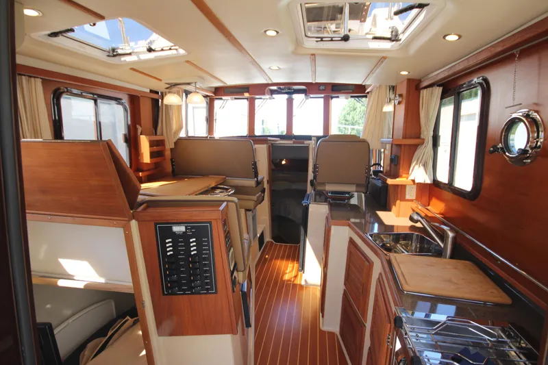 Slide: The Image of 2020 Ranger Tugs R-31 Command Bridge LE interior with wood finish and modern amenities. - 33