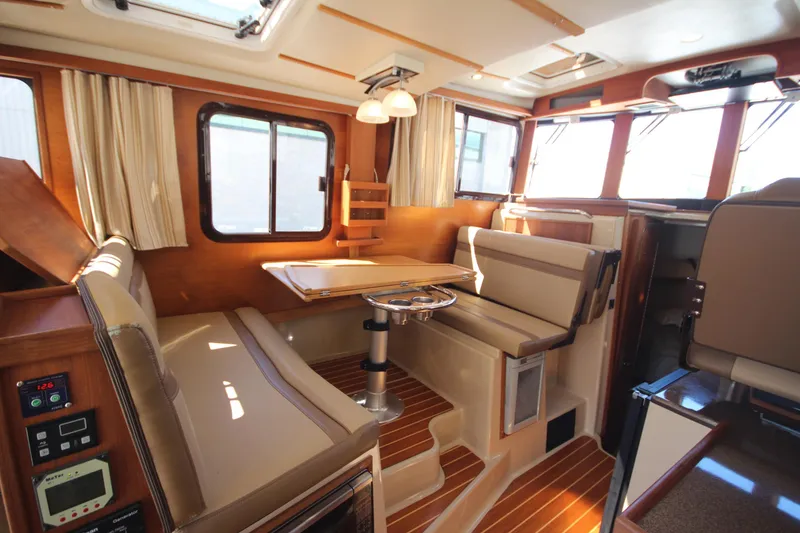 Slide: The Image of 2020 Ranger Tugs R-31 Command Bridge LE interior with seating and dining area. - 34