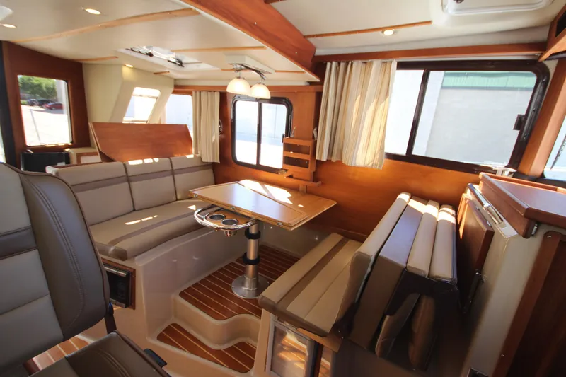 Slide: The Image of 2020 Ranger Tugs R-31 Command Bridge LE interior with seating and dining area. - 35