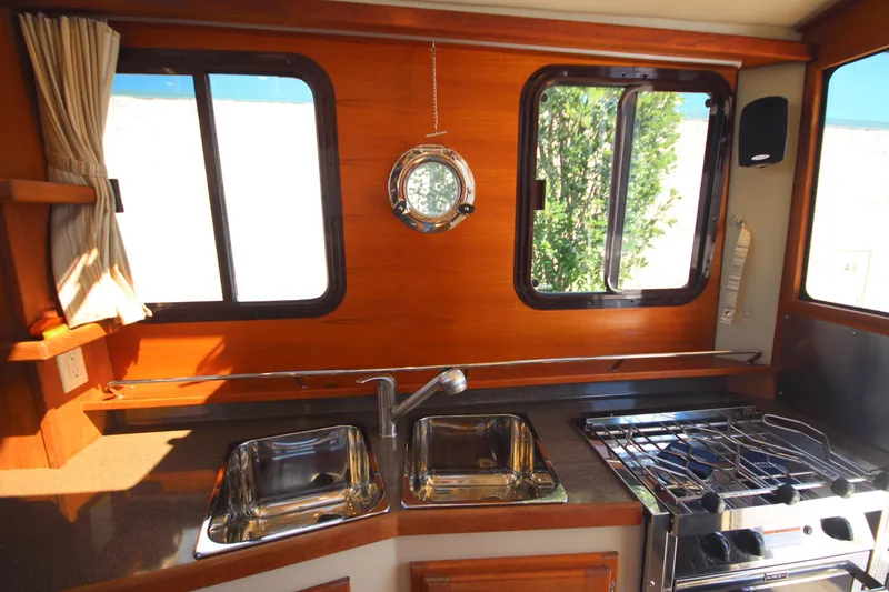 Slide: The Image of 2020 Ranger Tugs R-31 Command Bridge LE kitchen with sink and stove. - 38