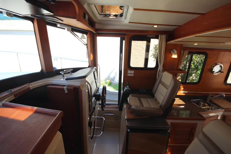 Slide: The Image of Interior of 2020 Ranger Tugs R-31 Command Bridge LE, featuring helm and seating area. - 40