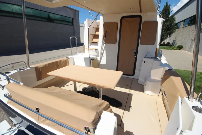 Slide: The Image of 2020 Ranger Tugs R-31 Command Bridge LE, spacious deck with seating and table. - 7