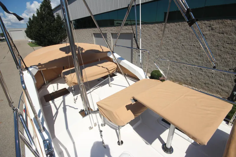 Slide: The Image of 2020 Ranger Tugs R-31 Command Bridge LE with beige seating and table on deck. - 8