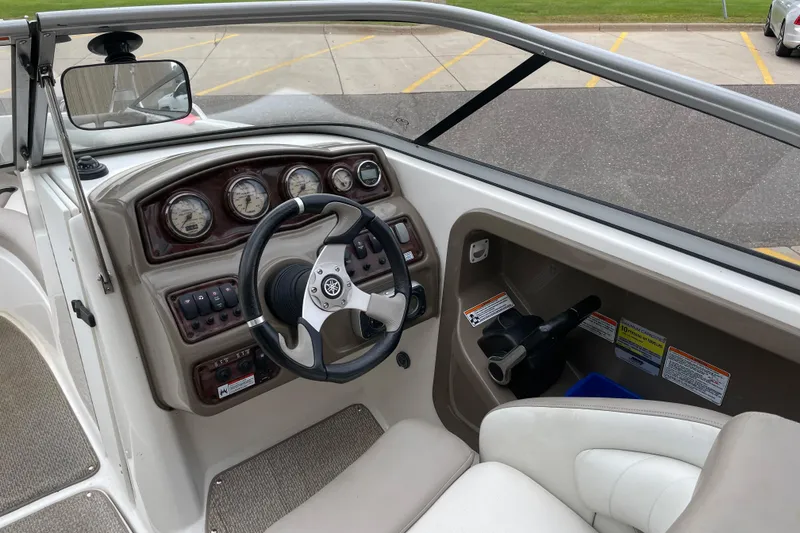 Slide: The Image of 2009 Yamaha Boats 232 Limited S dashboard with steering wheel and control panel. - 14