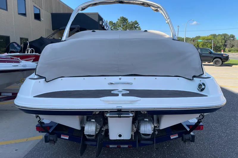 Slide: The Image of 2009 Yamaha Boats 232 Limited S with cover, parked outdoors. - 2