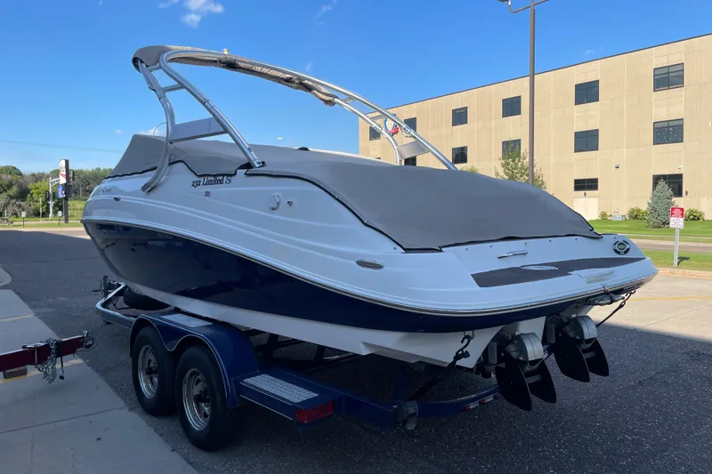 Slide: The Image of 2009 Yamaha Boats 232 Limited S on trailer, parked outdoors near a building. - 4