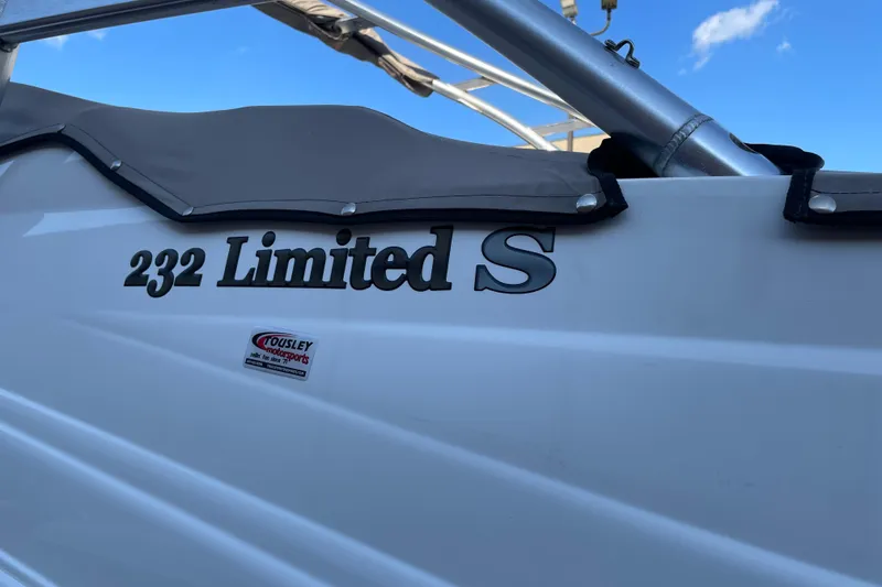 Slide: The Image of 2009 Yamaha Boats 232 Limited S with cover, under clear blue sky. - 6