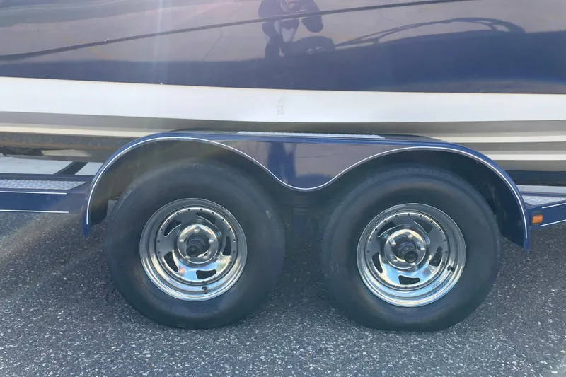 Slide: The Image of Trailer wheels of a 2009 Yamaha Boats 232 Limited S on asphalt. - 8