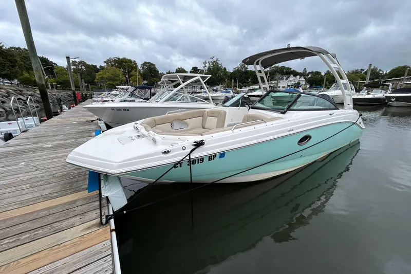 The Image of 2022 NauticStar 243 DC boat docked in a marina, featuring sleek design and spacious seating. - 0