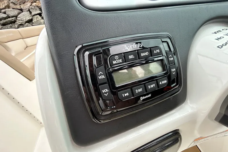Slide: The Image of Infinity stereo system on 2022 NauticStar 243 DC boat dashboard. - 18