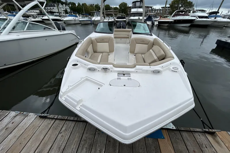 Slide: The Image of 2022 NauticStar 243 DC boat docked at marina, featuring spacious seating. - 5