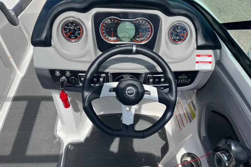 Slide: The Image of 2015 Chaparral Vortex 223 VRX boat dashboard with steering wheel and gauges. - 10